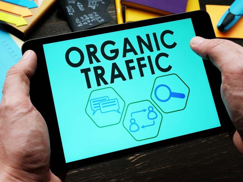 The words Organic Traffic on a tablet, implying the reader is studying up on SEO.